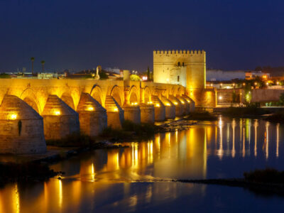 Illuminated Puente Romano, Roman bridge, across Guadalquivir river and and Torre de Calahorra, Calahorra Tower, Cordoba, Andalusia, Spain