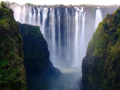 A beautiful shot of a waterfall surrounded by trees and hills