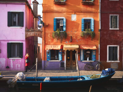 blue boat on river near orange building