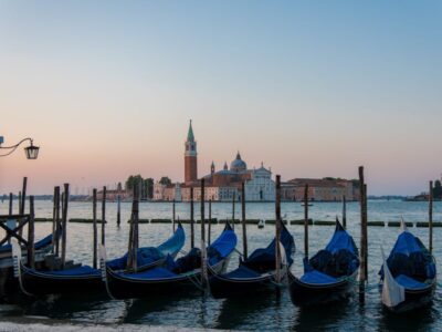 A high angle shot of gondolas parked in the canal in Venice, Italy