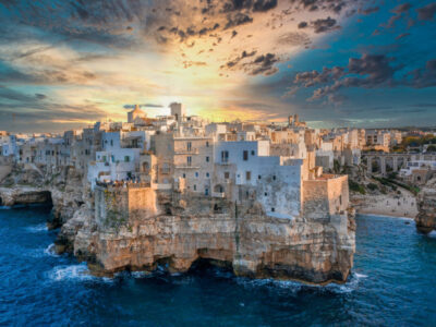 Aerial panoramic cityscape of Polignano a Mare town, Puglia region, Italy near Bari city, Europe. Superb scenic view of Adriatic sea. Traveling concept background.