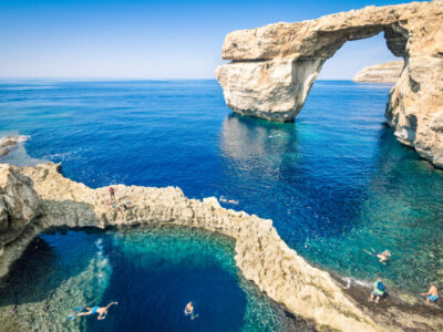 The world famous Azure Window in Gozo island - Mediterranean nature wonder in the beautiful Malta - Unrecognizable touristic scuba divers