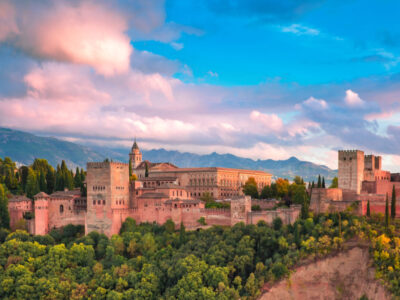 Palace and fortress complex Alhambra with Comares Tower, Palacios Nazaries and Palace of Charles V during sunset in Granada, Andalusia, Spain