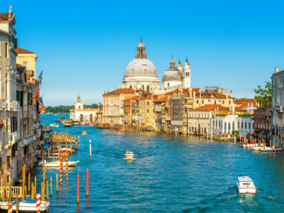 Grand Canal in Venice on a sunny day, Italy. Venice in the sunlight. Scenic panoramic view of Venice in summer. Cityscape and landscape of Venice. Romantic water trip in Venezia.