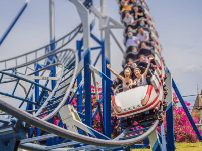Happy friends in amusement park on a summer day.