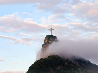 low-angle-view-jesus-christ-statue-mountain-against-cloudy-sky