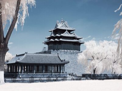 The Forbidden city corner tower in Beijing surrounded by frosty and snow-covered trees in China