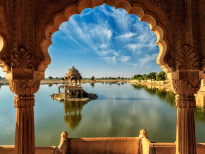Indian landmark Gadi Sagar - artificial lake view through arch. Jaisalmer, Rajasthan, India