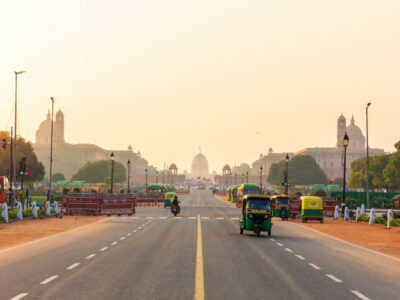 Sunset traffic in New Delhi, tuc tuc cars on the road to the Presidential Residance.